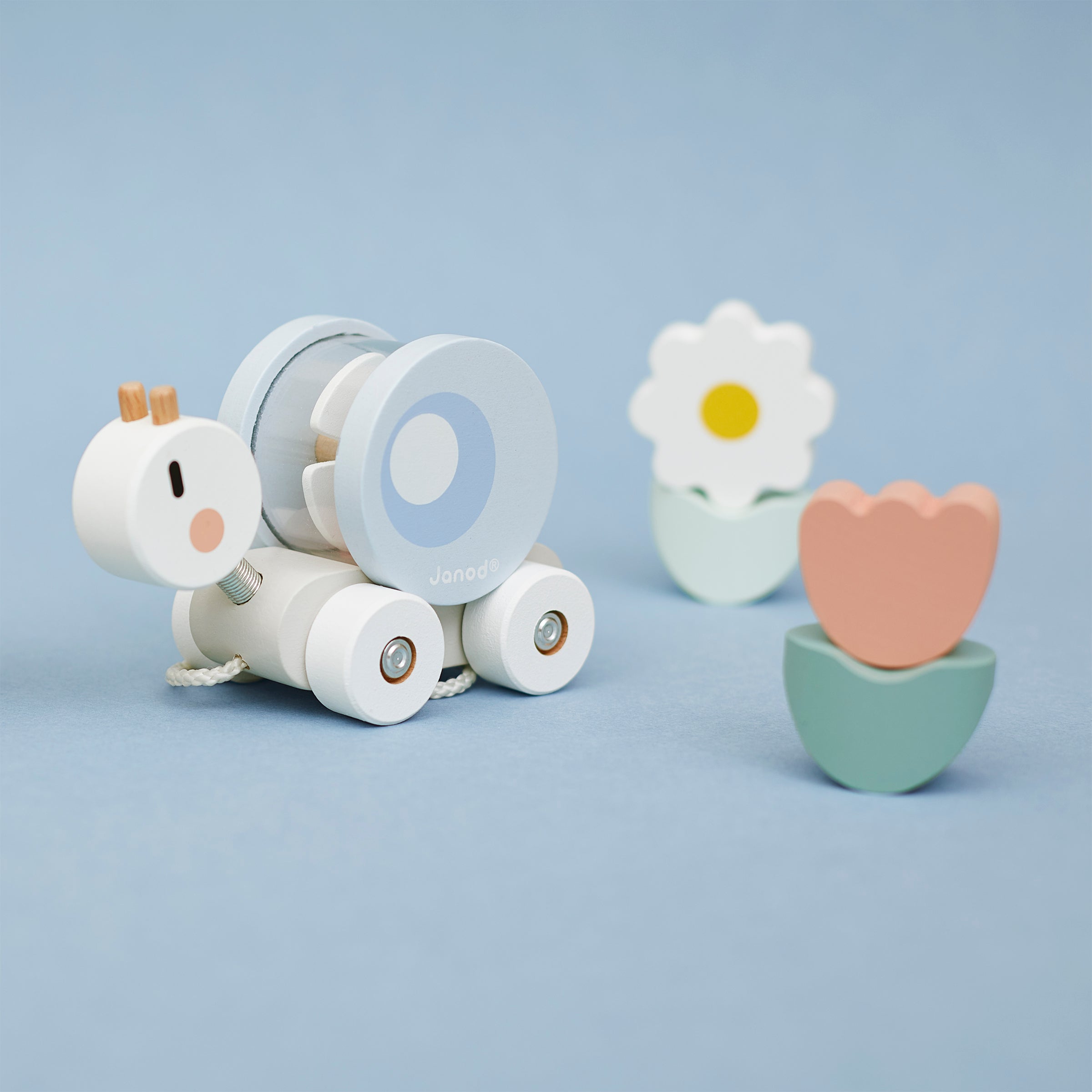 Janod Pull along snail on a blue background