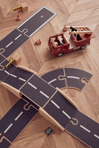 Kids Concept wooden car track on a wooden floor with a fire truck (not included)