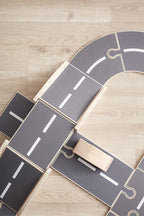 Close-up of a Kids Concept wooden car track on a wooden floor