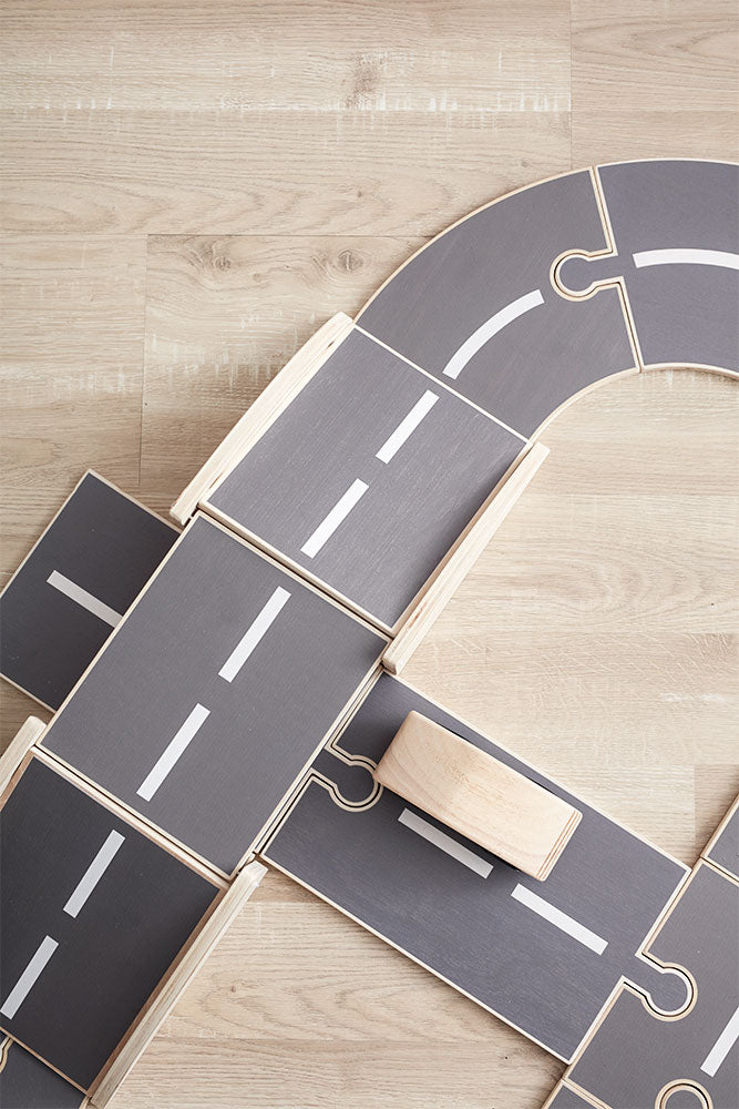 Close-up of a Kids Concept wooden car track on a wooden floor