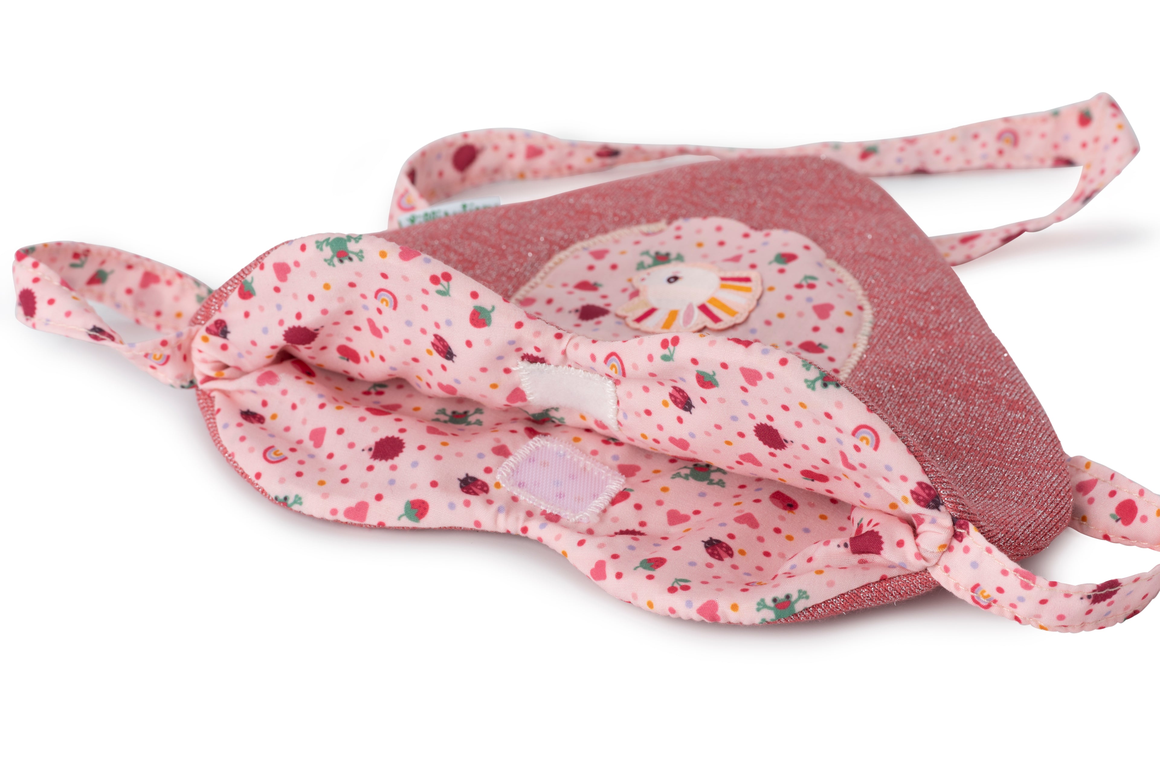 Close-up of the inner lining of a Lilliputiens Aline doll with heart bag on a white background