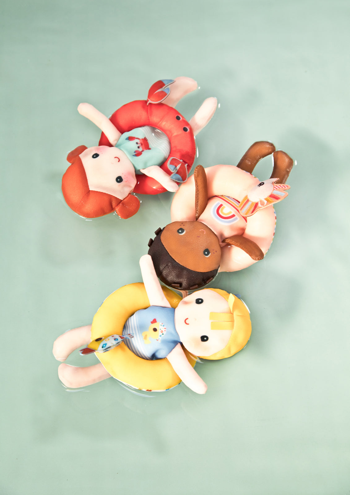 Lilliputiens bath doll crab floating with other bath dolls in water