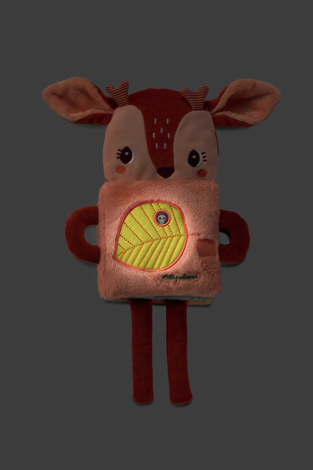 Lilliputiens Stella the Fawn cuddle toy featuring a glowing leave on a dark background