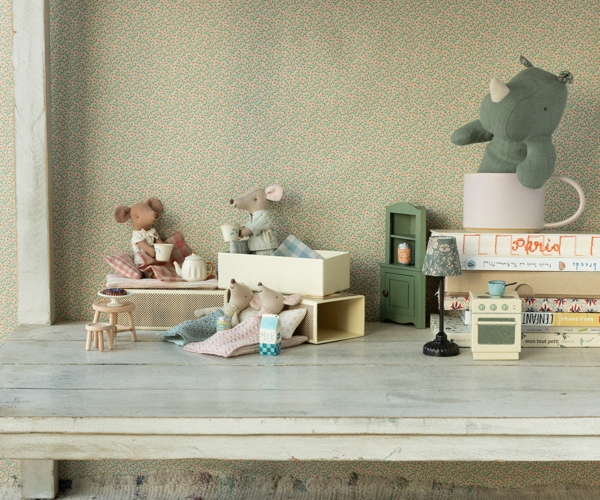 Maileg Little Brother Mouse in matchbox with polka dot pyjamas styled with other toy mice, a plush toy and doll furniture (not included)