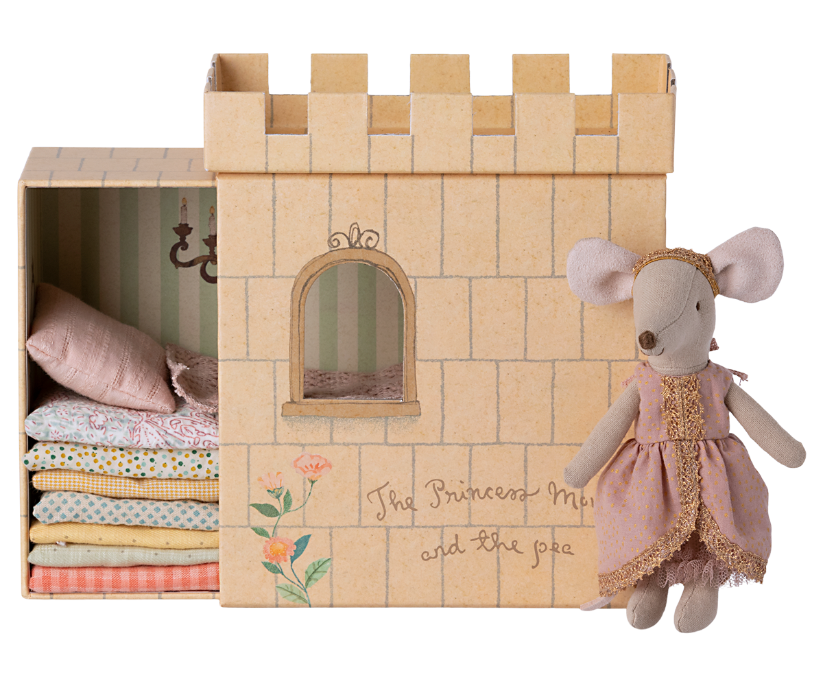 Maileg Princess and the Pea big sister mouse next to cardboard castle with stacked mattresses