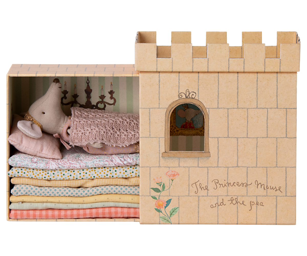 Maileg Princess and the Pea big sister mouse sleeping on stacked mattresses inside cardboard castle