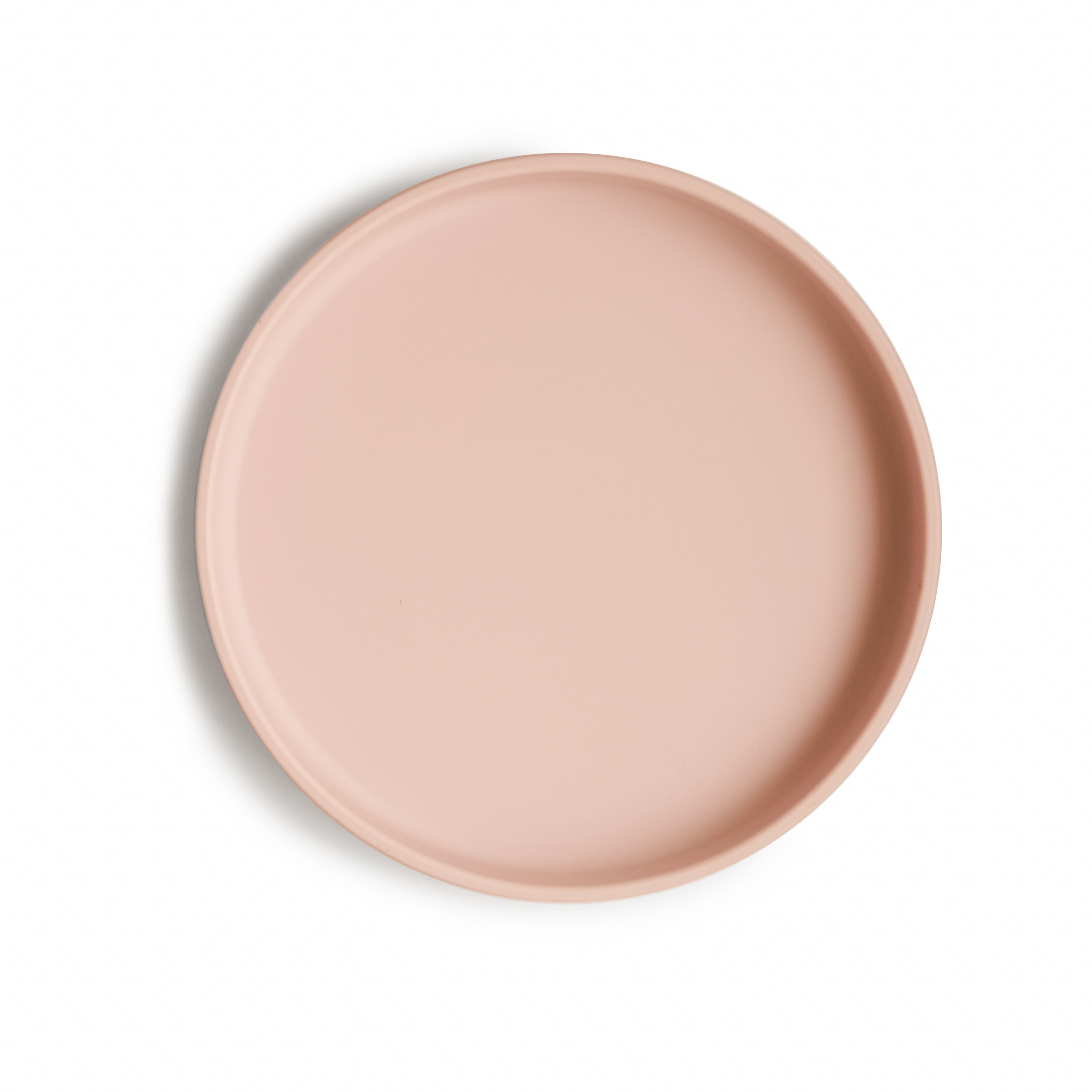 Top view of a Mushie classic silicone suction plate in Blush on a white background