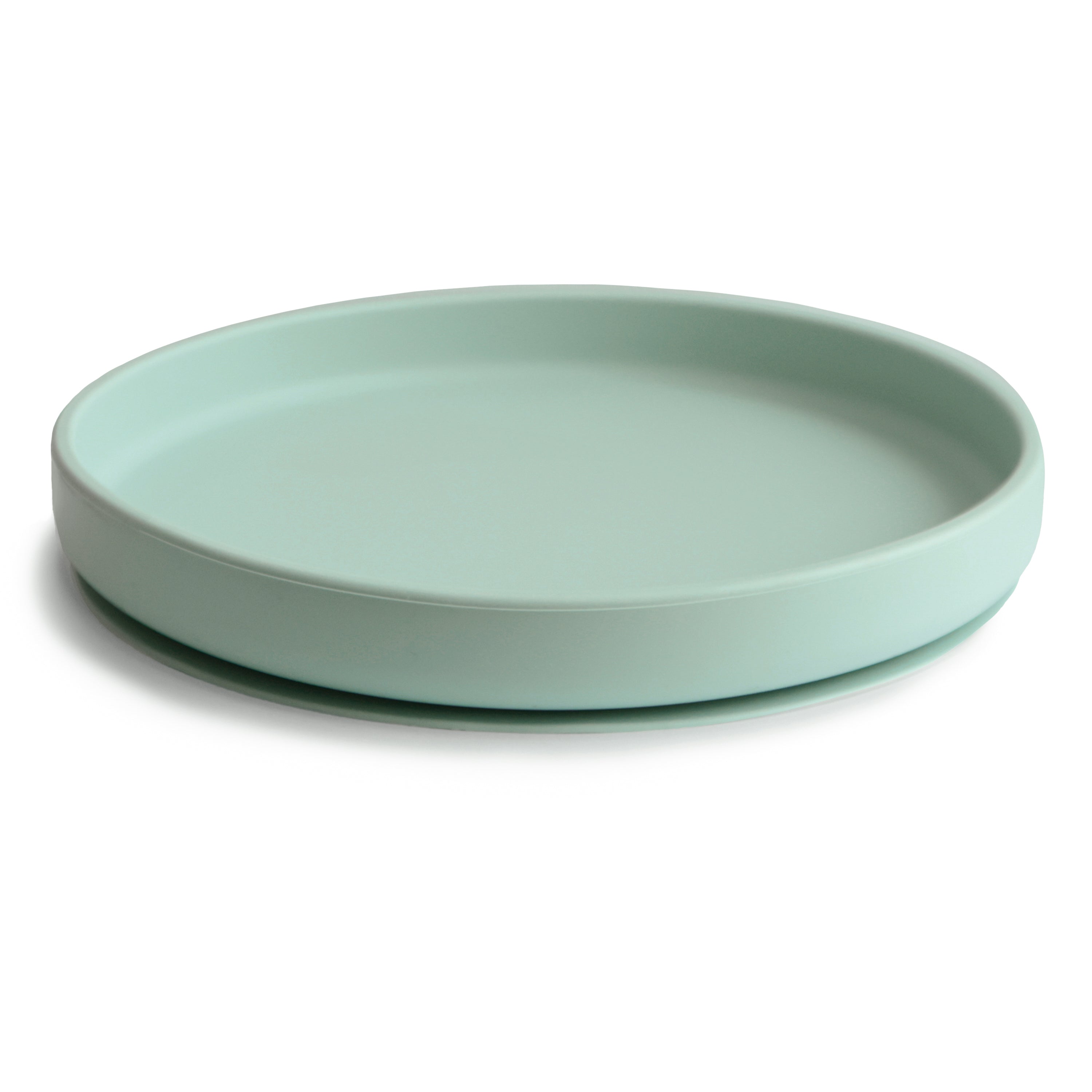 Side view of a Mushie classic silicone suction plate in Cambridge blue on a white background