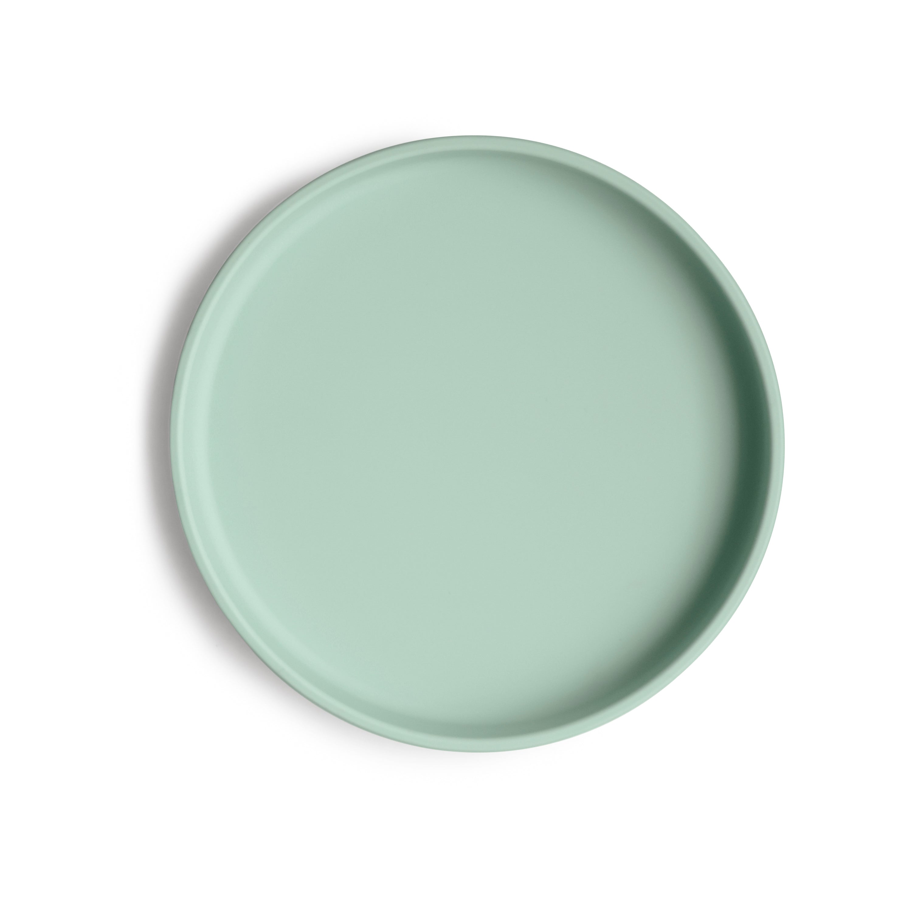 Top view of a Mushie classic silicone suction plate in Cambridge blue on a white background