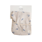 Mushie long sleeve bib in Whales print in original packaging on a white background