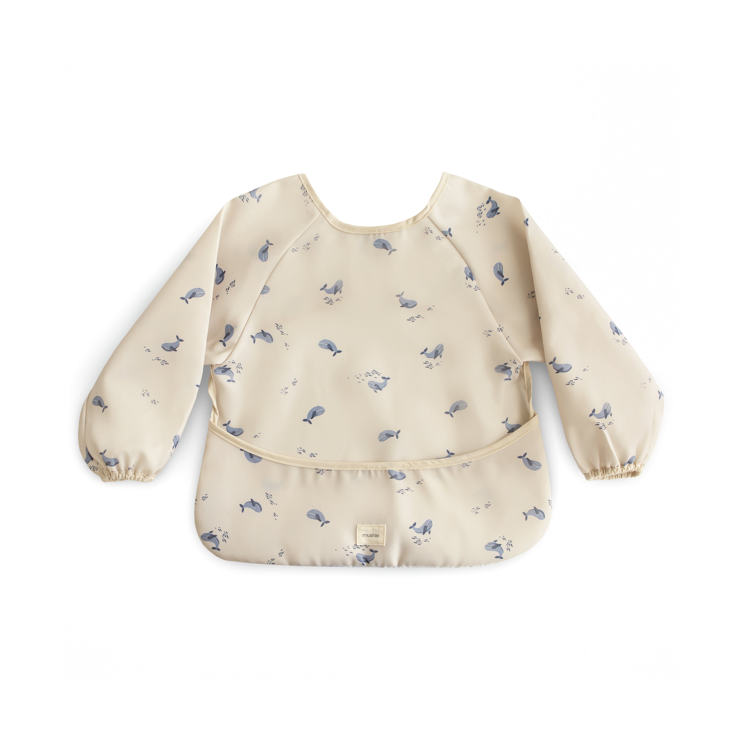 Mushie long sleeve bib in Whales print on a white background