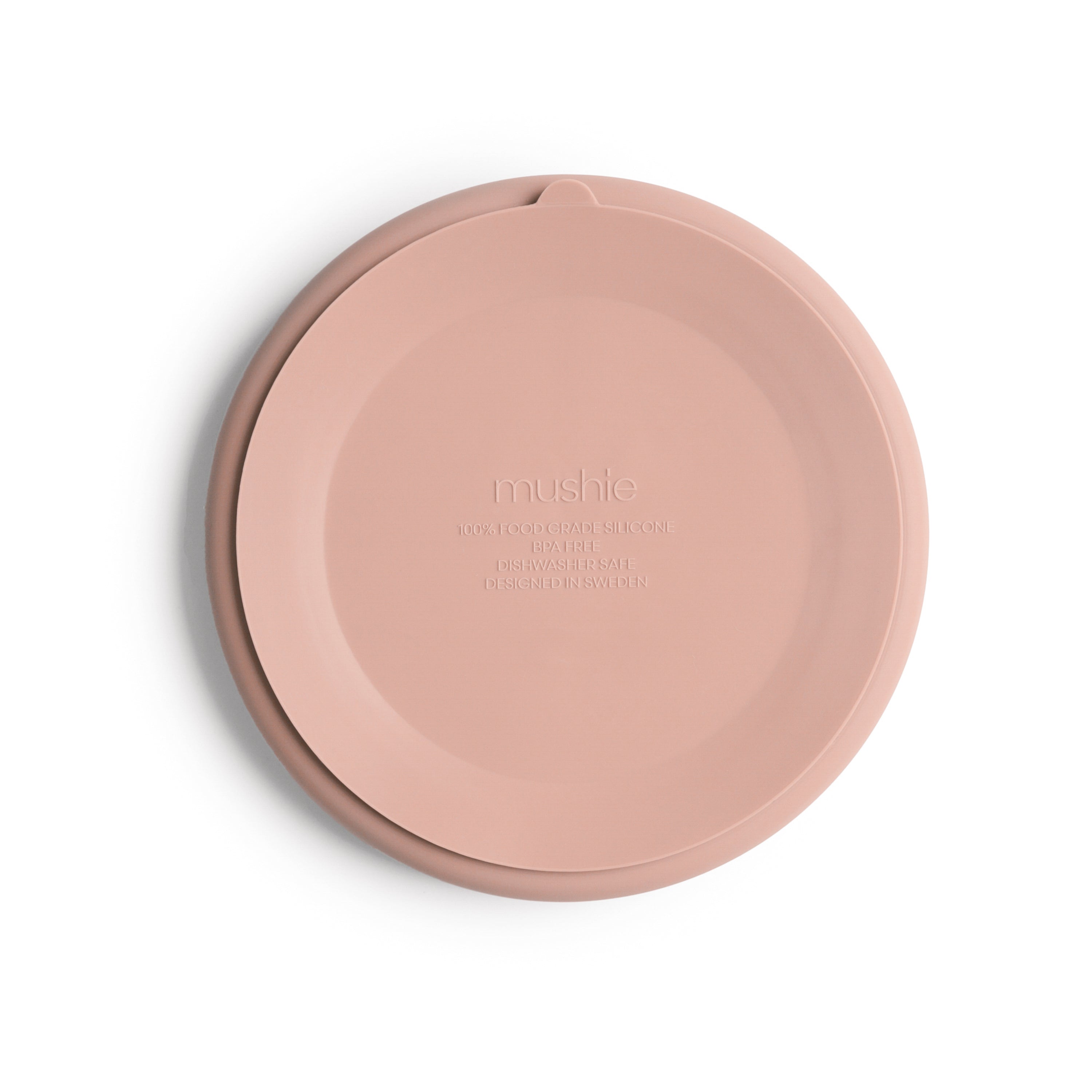 Bottom view of Mushie silicone suction divided plate in Blush on a white background