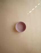 Mushie silicone suction bowl in Blush  on a beige background