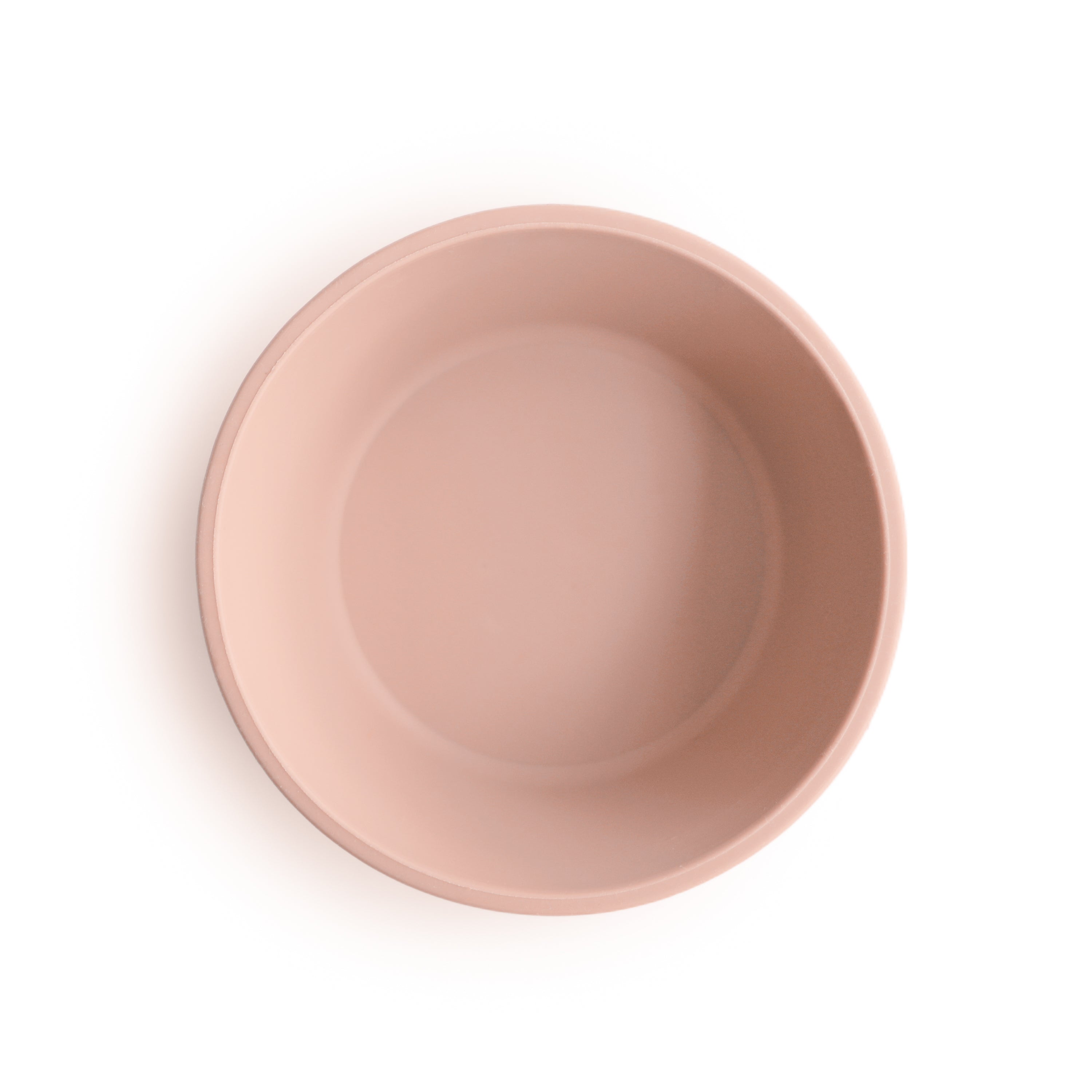 Top view of Mushie silicone suction bowl in Blush on a white background