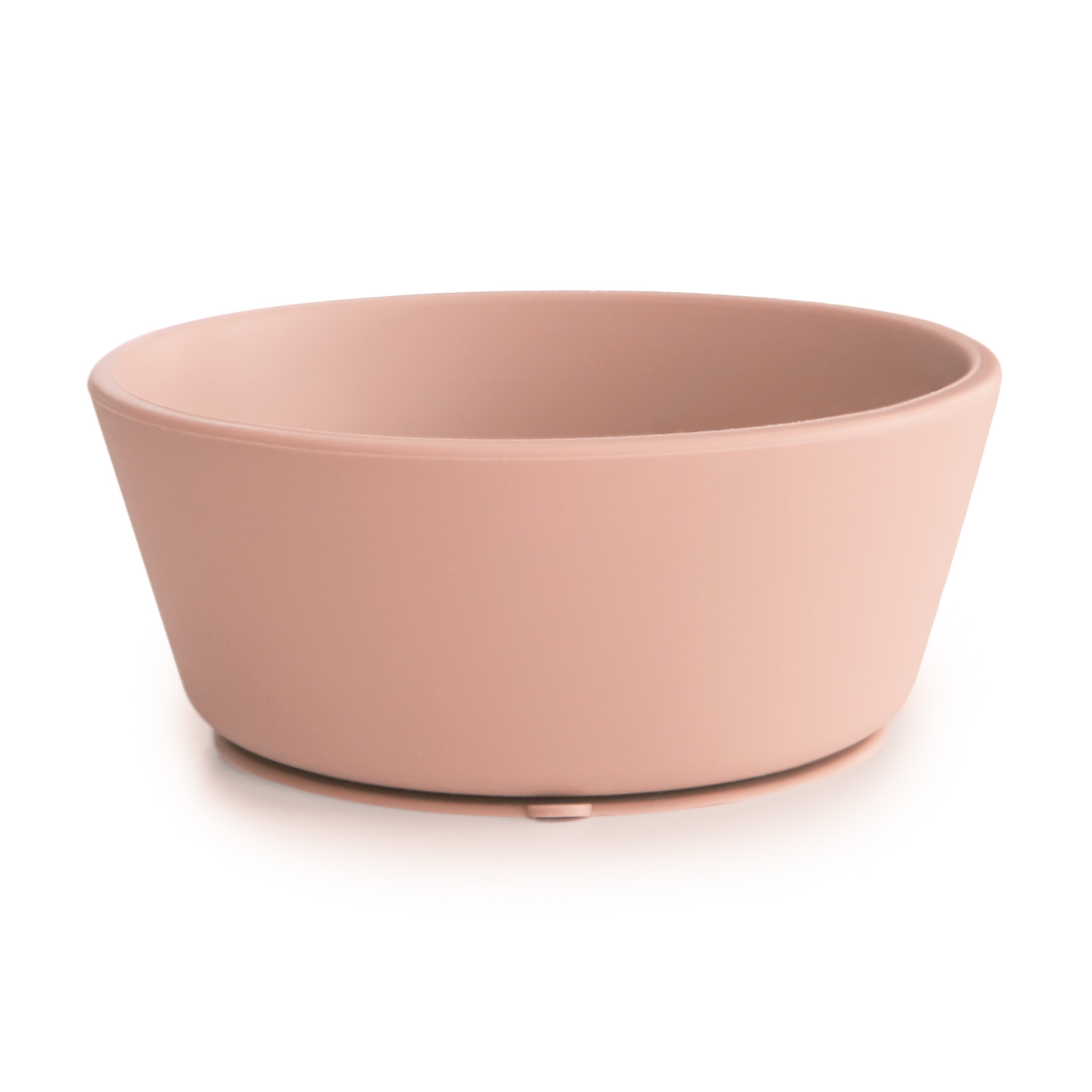 Side view of a Mushie silicone suction bowl in Blush  on a white background