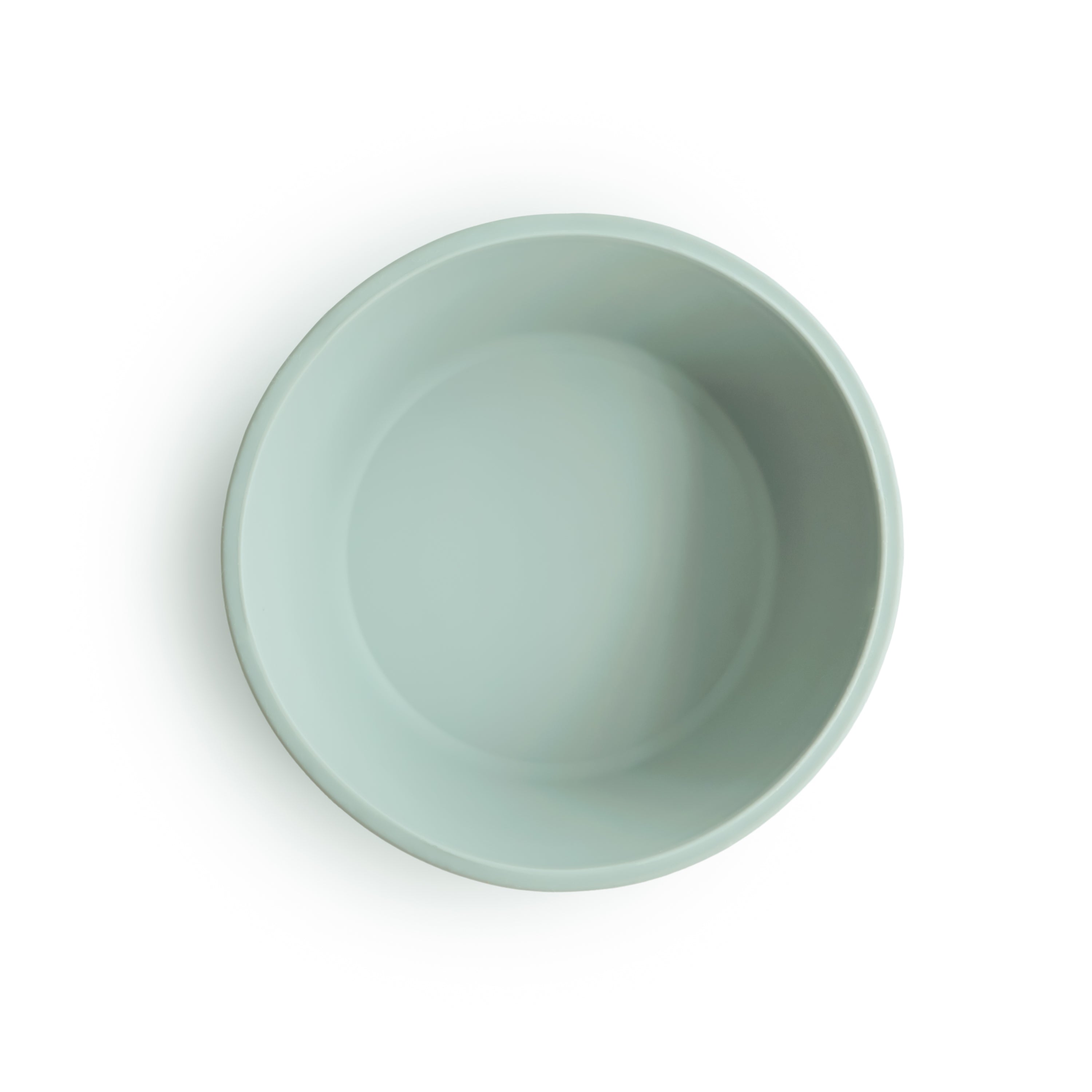 Top view of a Mushie silicone suction bowl in Cambridge blue on a white background