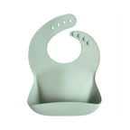Mushie silicone bib in Cambridge blue on a white background