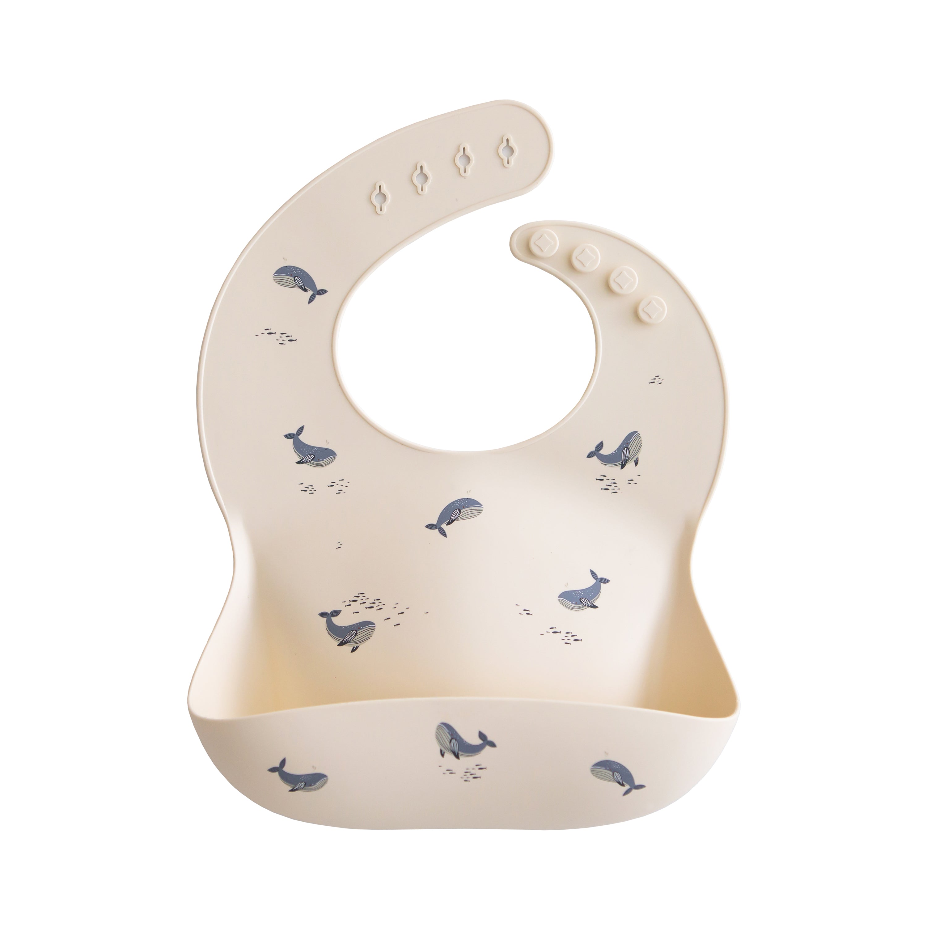 Mushie silicone bib in Whales print on a white background