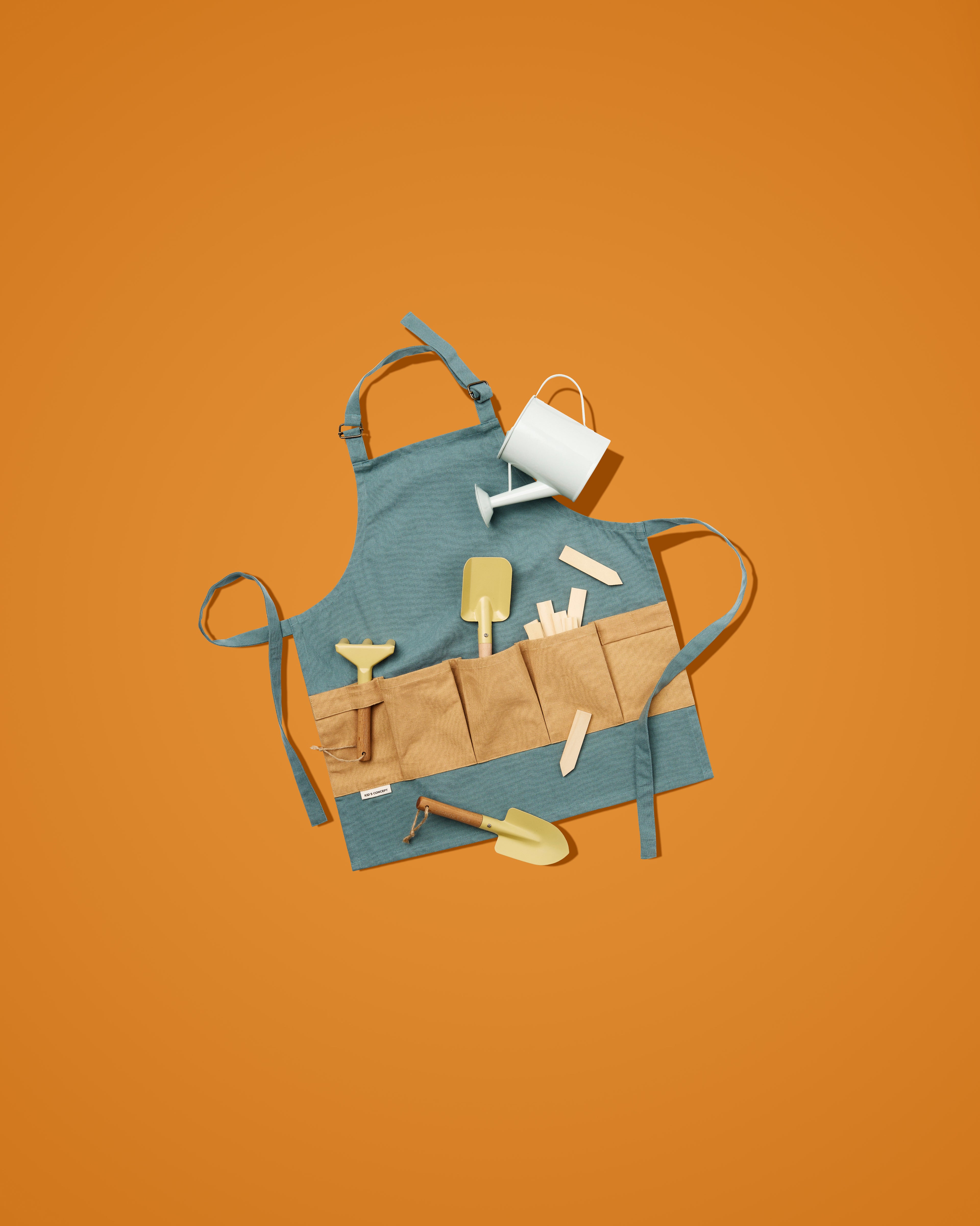 Kid's Concept gardening tool set for kids on an orange background