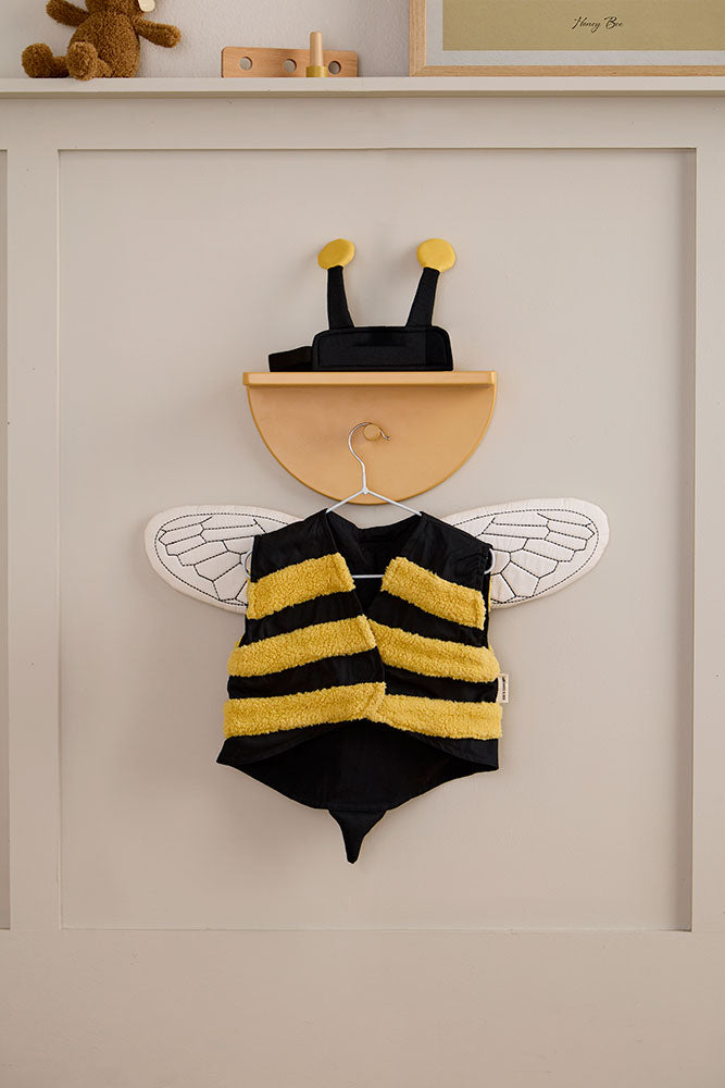 Kid's Concept bumblebee dress-up costume on a wall with a neutral background