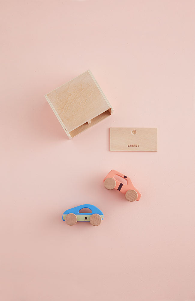 Kids Concept cars with garage play set on a pink background