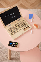 Kid's Concept wooden computer play set on a pink table