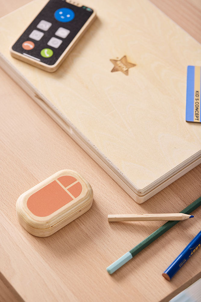 Close-up of a Kid's Concept wooden computer play set on a neutral background