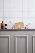 Kid's Concept doctor’s case play set in nature on a gray cabinet against a white tiled wall