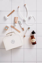 Kid's Concept doctor’s case play set in white on a tiled surface