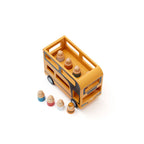 Top view of a Kid's Concept wooden double decker bus toy with figures on a white background