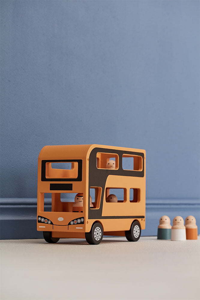 Kid's Concept wooden double decker bus toy with figures (included) on a blue and beige background