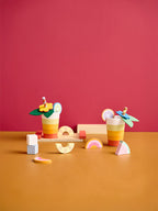 Kids Concept wooden drink play set  on a red and orange gradient background