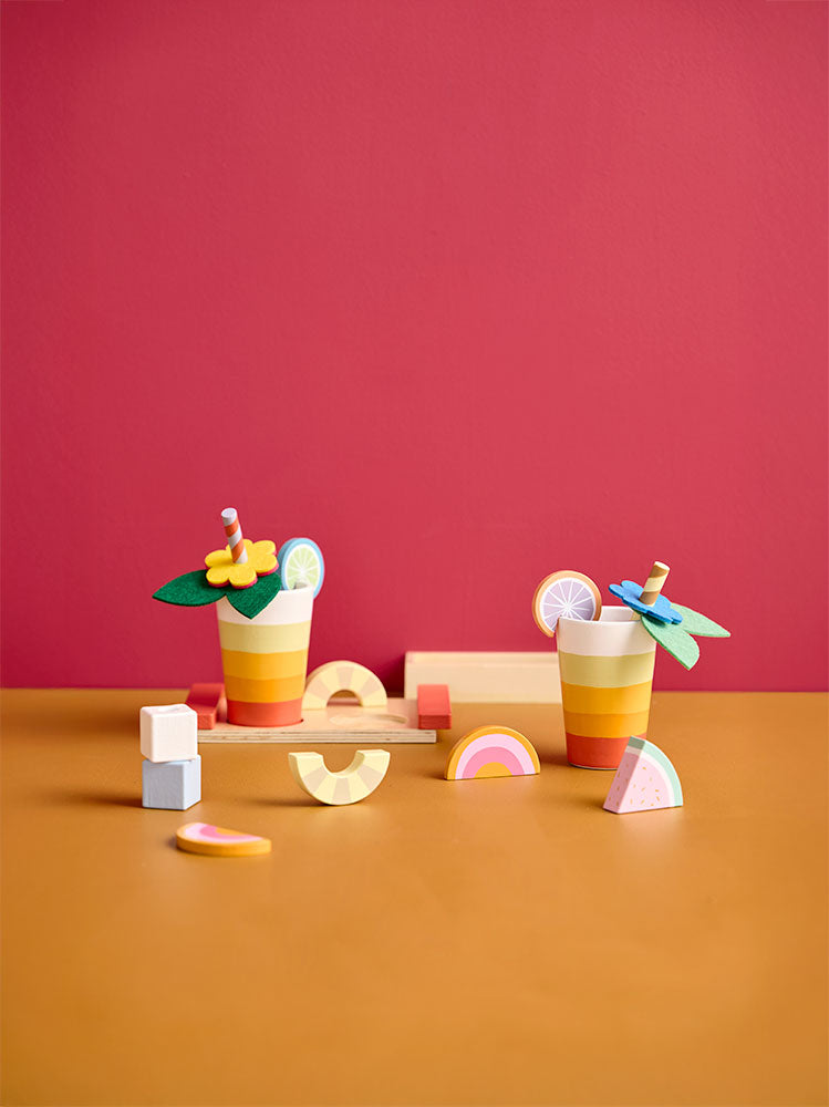 Kids Concept wooden drink play set  on a red and orange gradient background