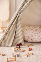 Kid's Concept wooden farm animals set styled in a neutral-colored kid's playroom