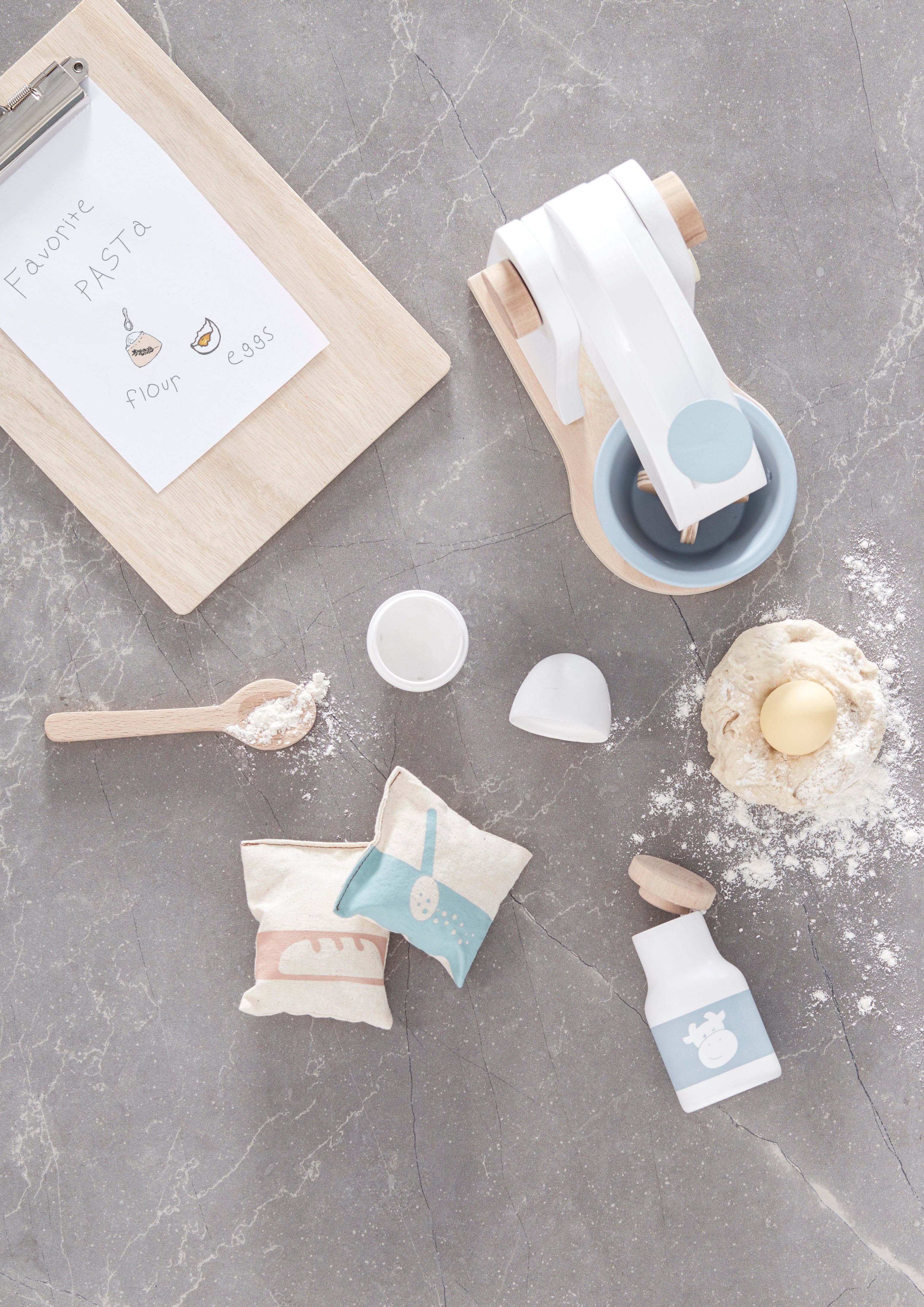 Kid's Concept wooden mixer set on a gray surface