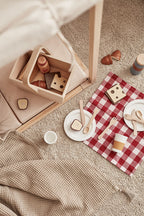 Kid's Concept picnic play set styled with a beige blanket on a beige carpet