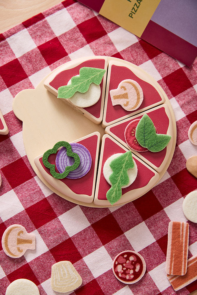 Kids concept pizza play kit with various toppings on a red and white checkered tablecloth