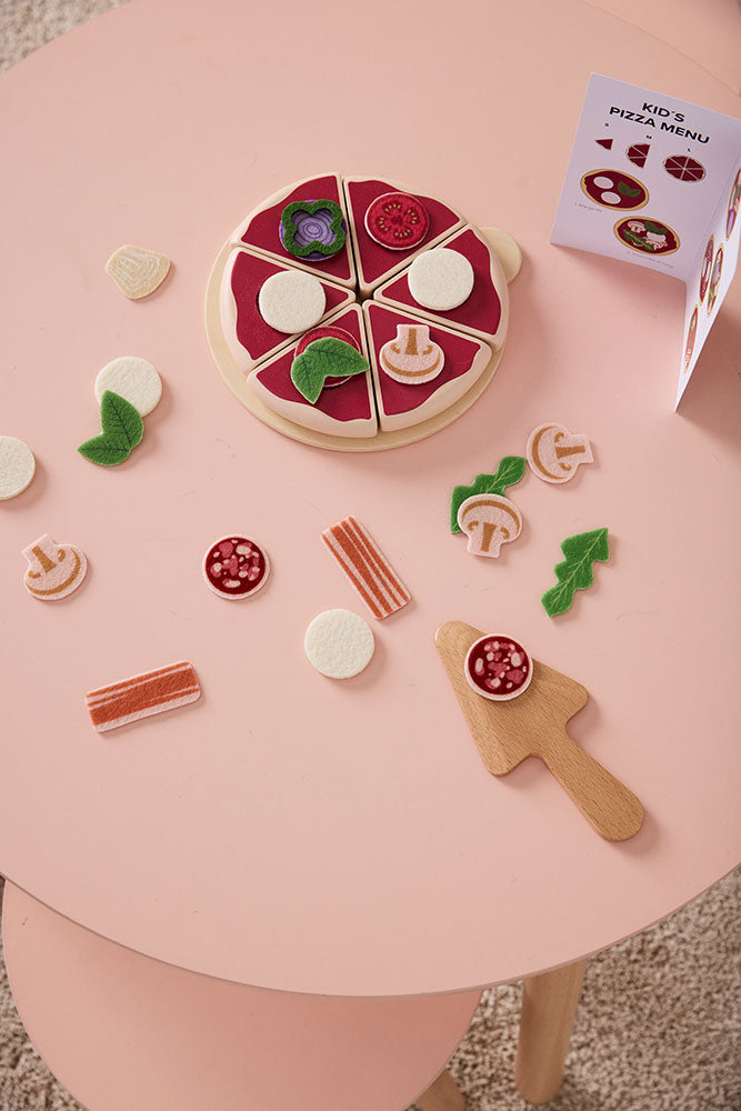 Kids Concept pizza play kit on a pink table