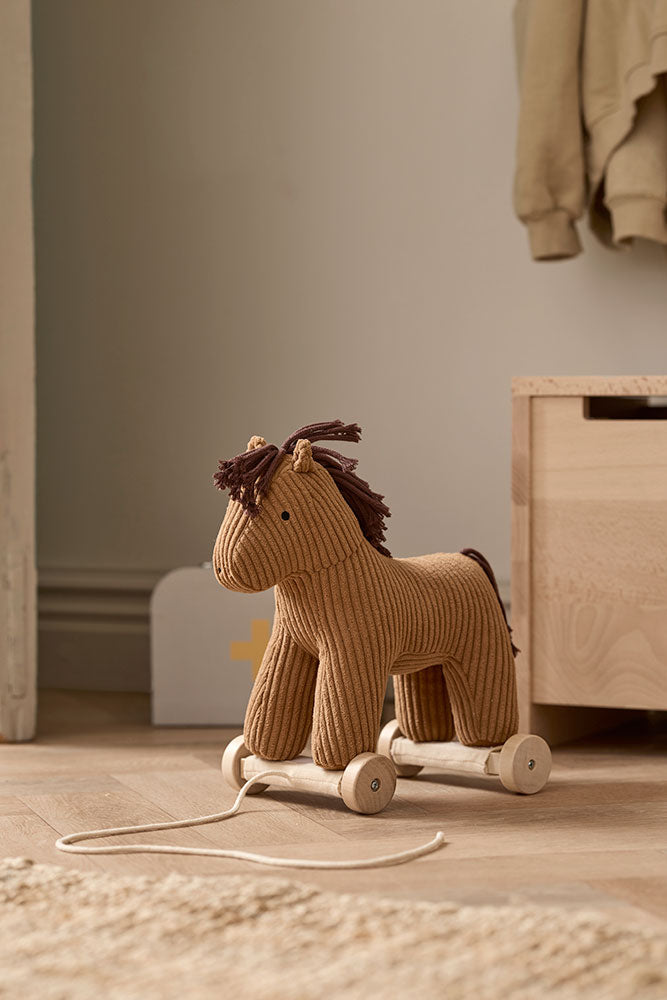 Kid's Concept pull-along horse Vera on a wooden floor in a room