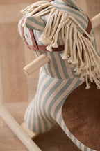 Close-up of Kid's Concept rocking horse Sam with fringed mane on a wooden floor