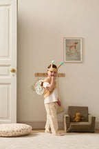 Child in a Kid's Concept snail dress-up costume standing in a room with a teddy bear (not included) and small chair
