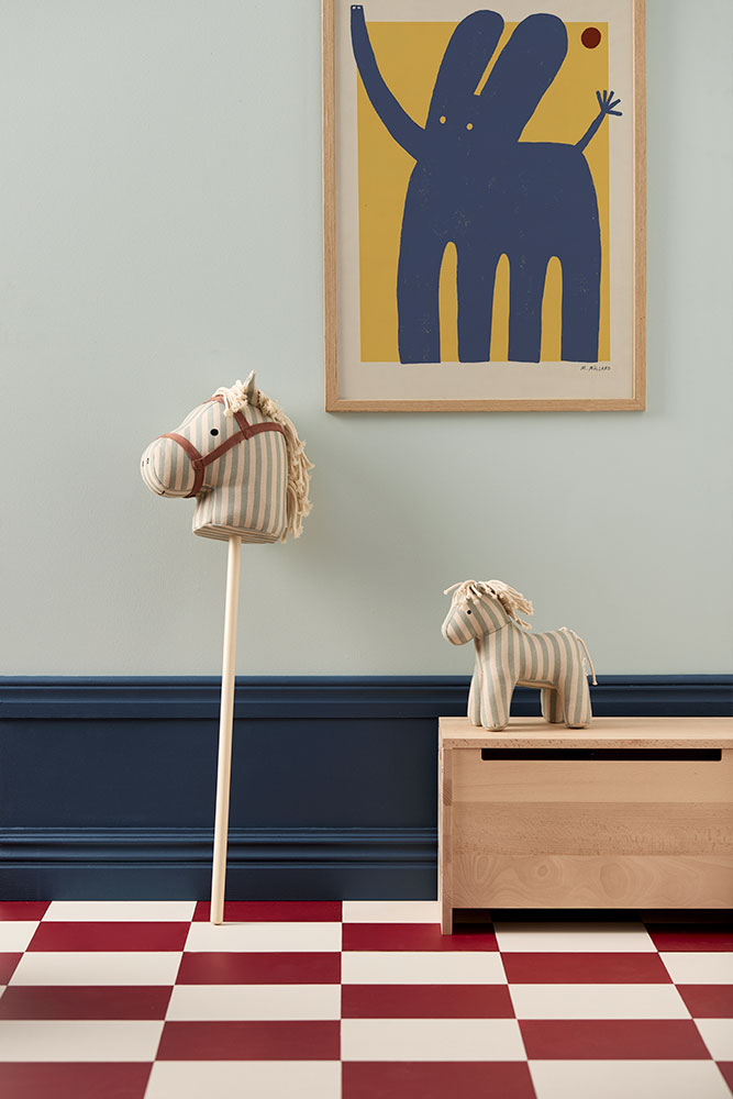 Children's room with Kid's Concept soft toy horse Sam and a hobby horse Sam (not included), abstract art on wall, and checkered floor