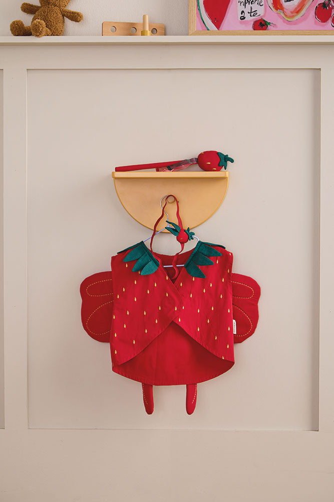 Kid's Concept strawberry fairy dress-up costume on a beige wall with toys (not included) in the background