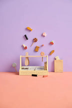 Kids Concept Swedish candy shop play set with various accessories on a pink and purple background