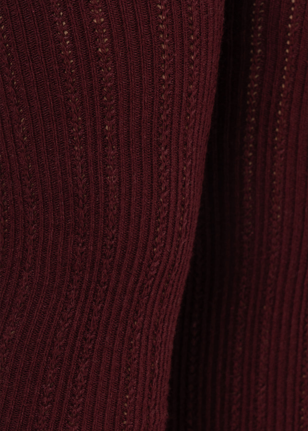 Close-up of the Konges Sløjd Bow 2-pack Pointelle Tights in Bordeaux/ Off white on a white background.