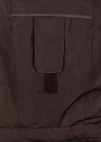Close-up of a pocket detail of the Konges Sløjd Award Snowsuit Solid in Chocolate Brown