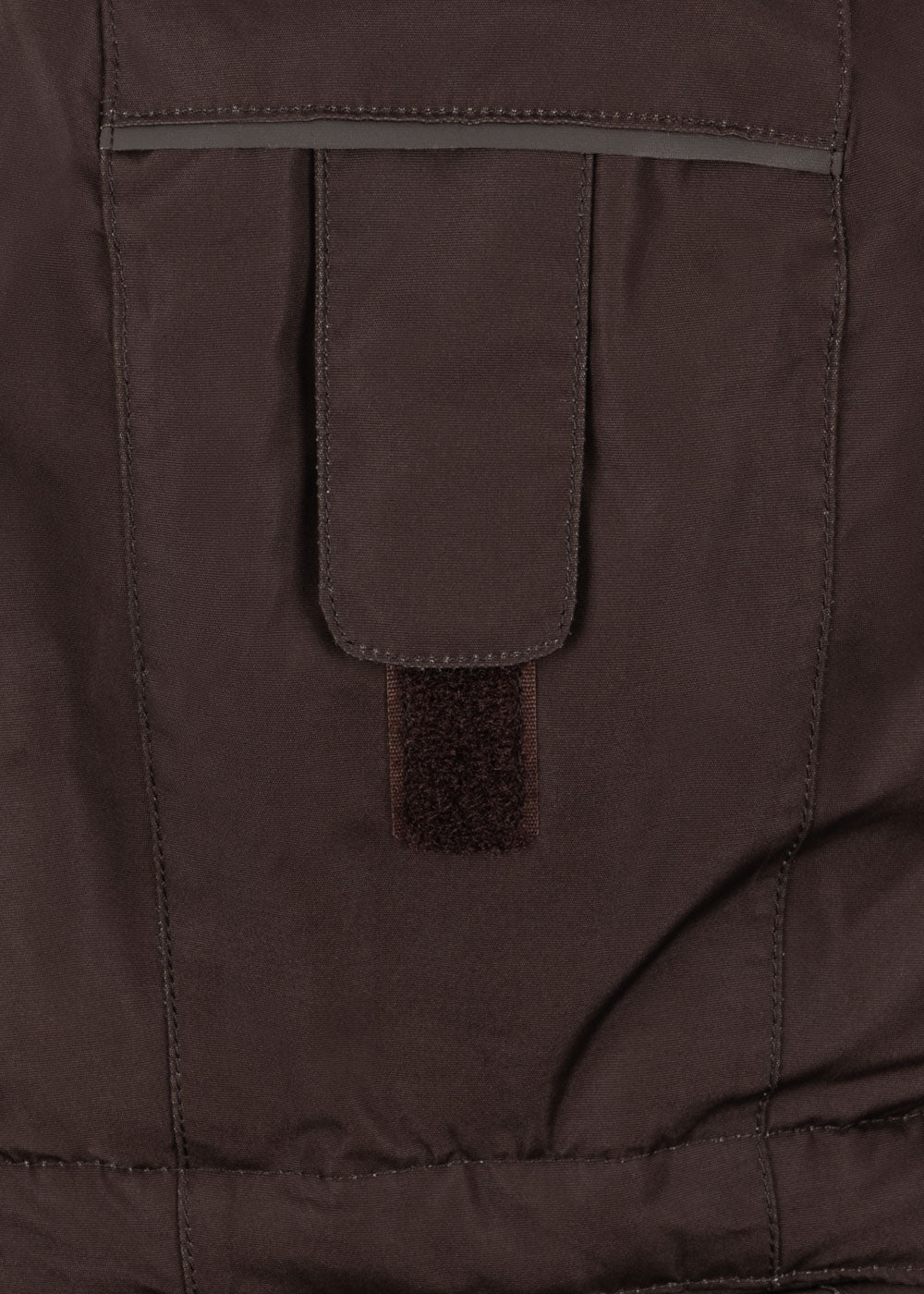 Close-up of a pocket detail of the Konges Sløjd Award Snowsuit Solid in Chocolate Brown