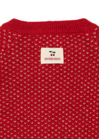 Close-u of the Konges Sløjd Belou cardigan in Cat Rouge on a white background.