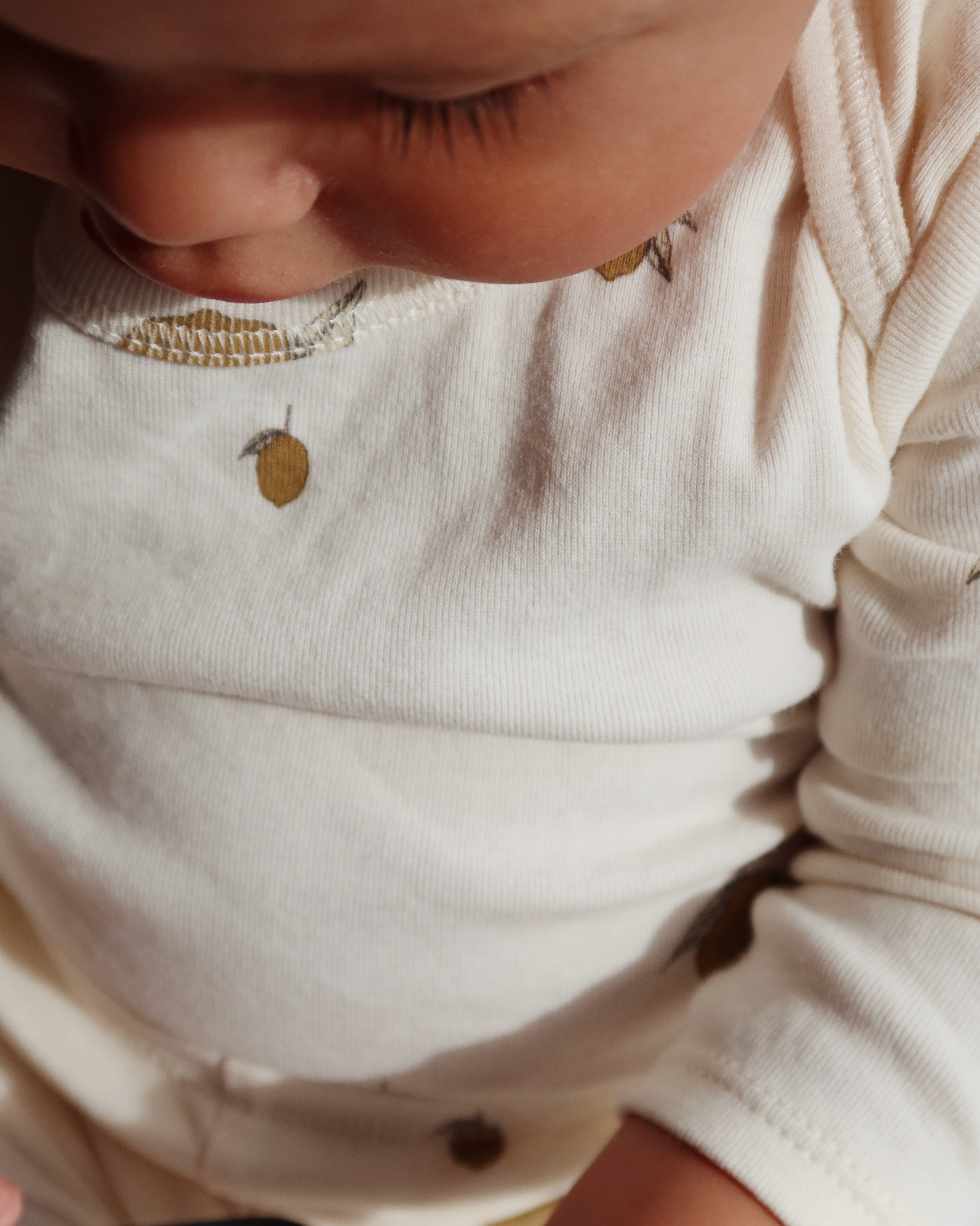 Close-up of a baby wearing Konges Sløjd Body in Lemon