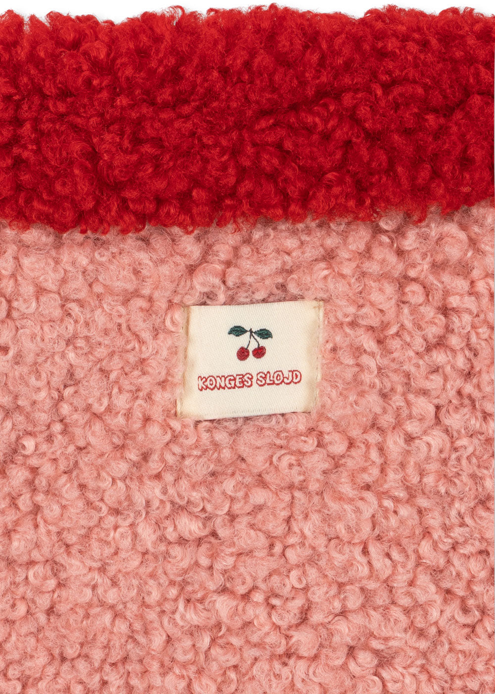 Close-up of the Konges Sløjd Calin Coat in Mellow Rose on a white background.